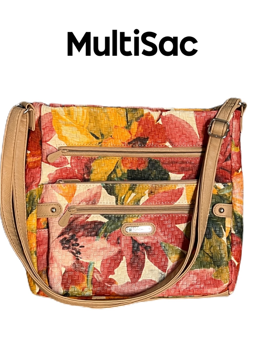 MultiSac floral woven multi-compartment shoulder bag with an adjustable strap.
